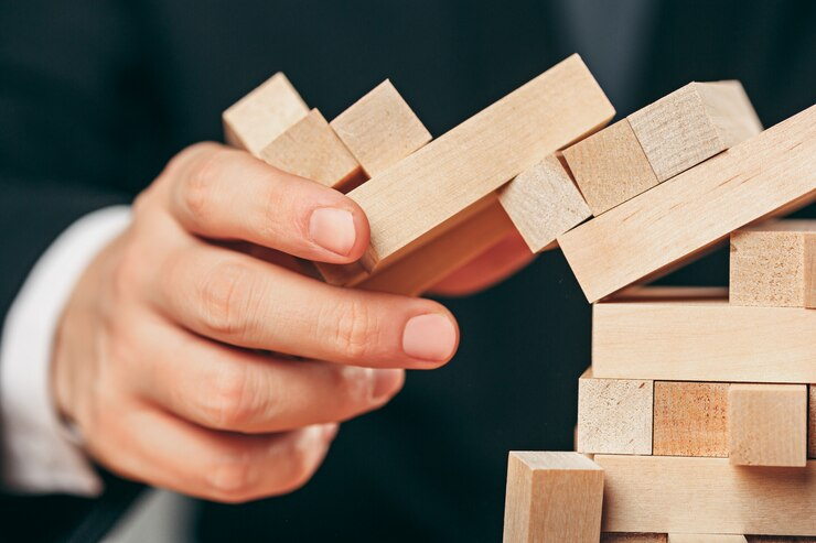 Man and Wooden Cubes on Table