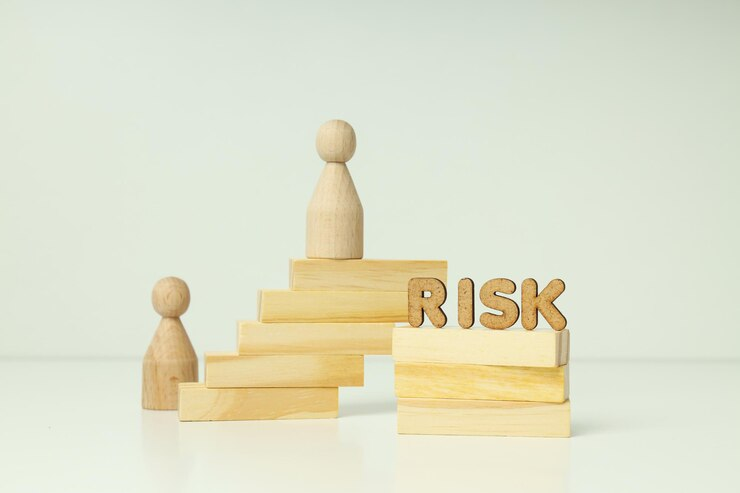 Wooden Figures and Word Risk Made of Wood