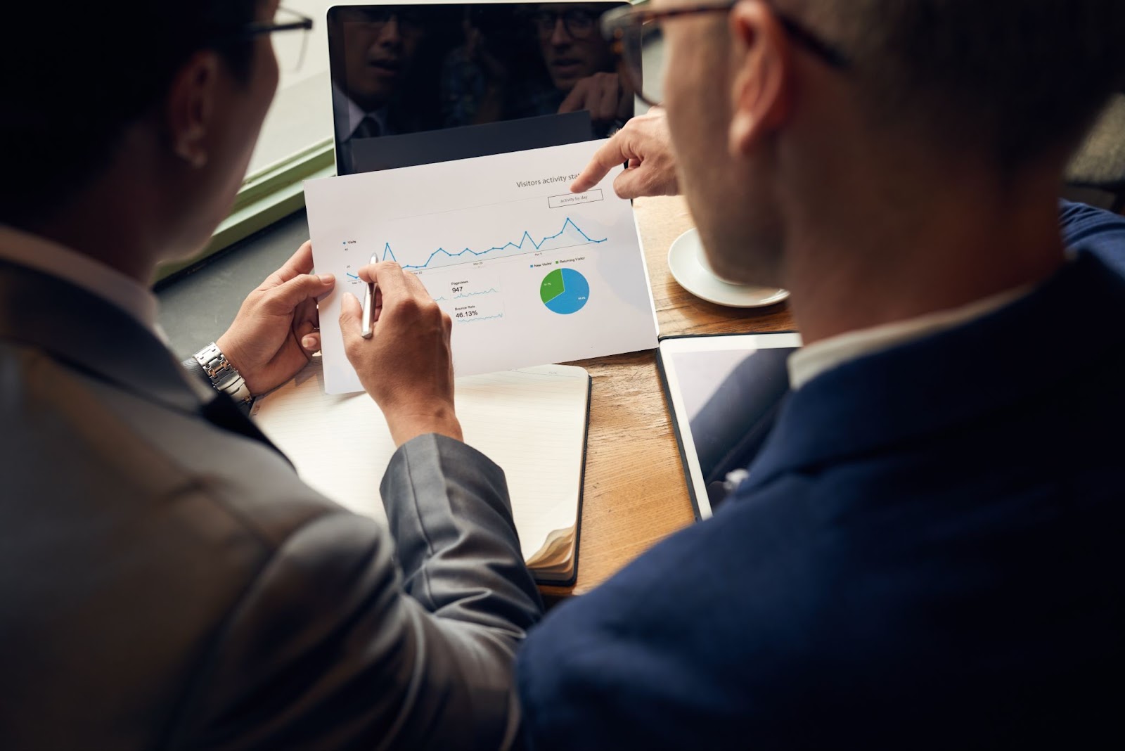 Two men analyzing business chart