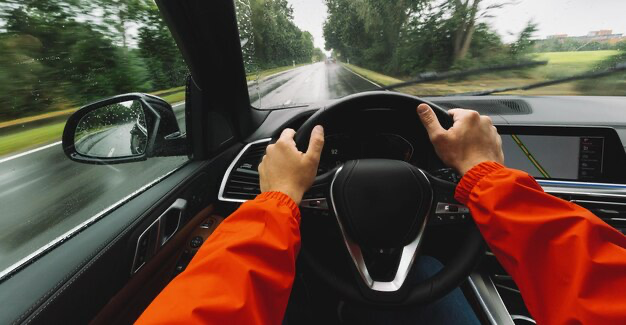 Car driver's hands on the steering wheel