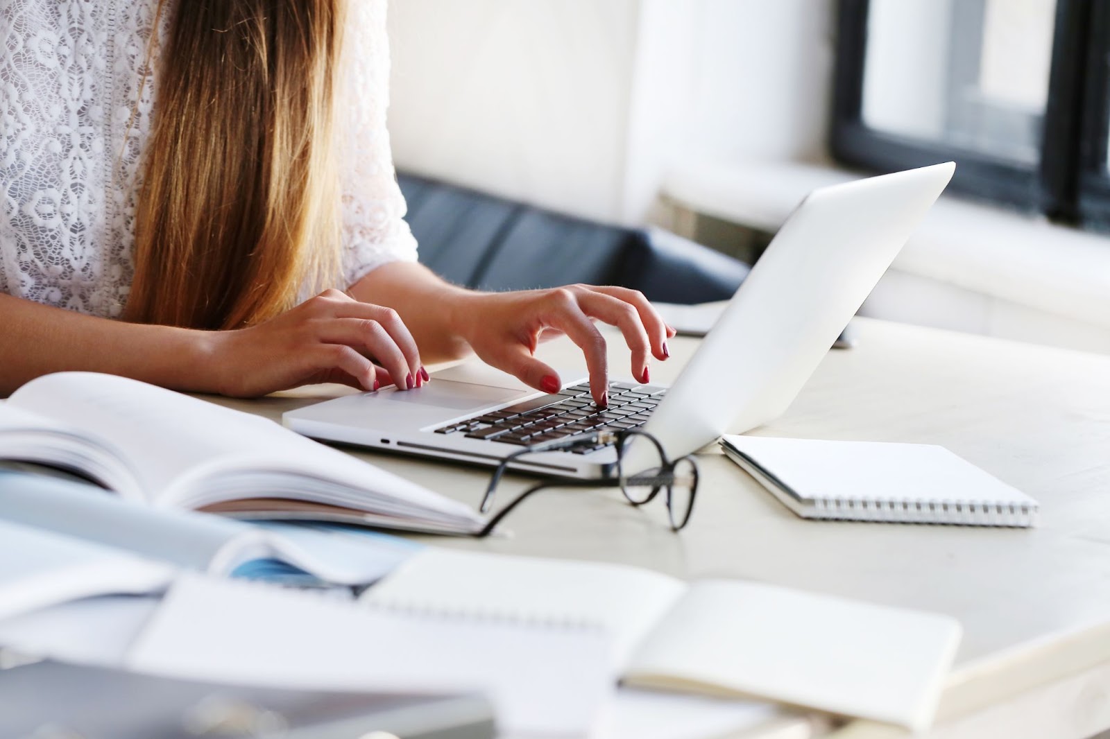 Close up of woman working at the office in laptop